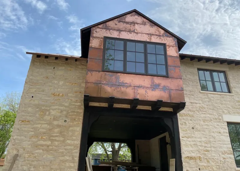 Copper metal panel facade on a stone building for Metal Roof Coating in Groves